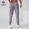 HUCAI OEM Men's Jogger Silicone Logo Embroidery Waterproof Zipper Sports Pants Manufacturer
